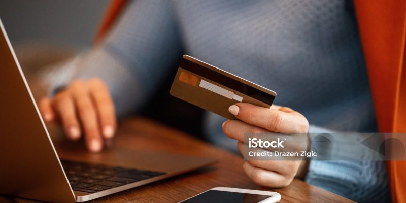 Unrecognizable woman using credit card and shopping online. Close up.